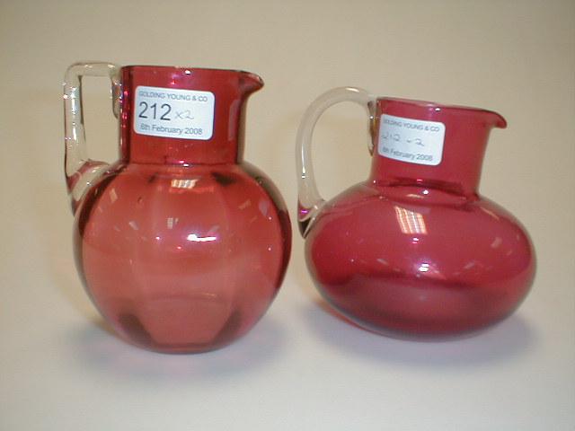 Appraisal: A cranberry glass jug of ovoid form with a clear