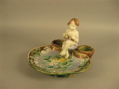 Appraisal: Continental Majolica sweetmeat dish th century Modeled as a putti