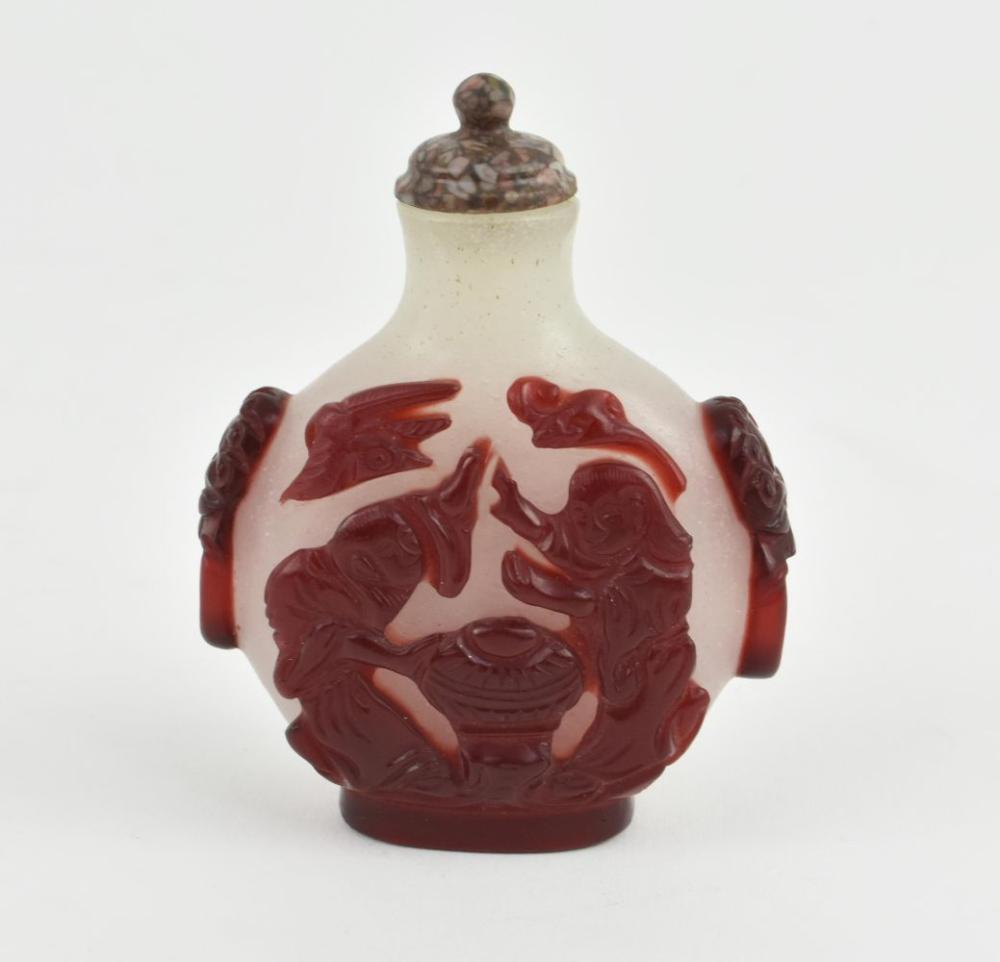 Appraisal: CHINESE RED OVER WHITE PEKING GLASS SNUFF BOTTLEThe flattened circular