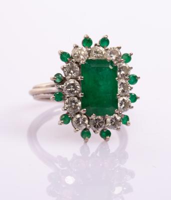 Appraisal: An emerald and diamond cluster ring the central step cut