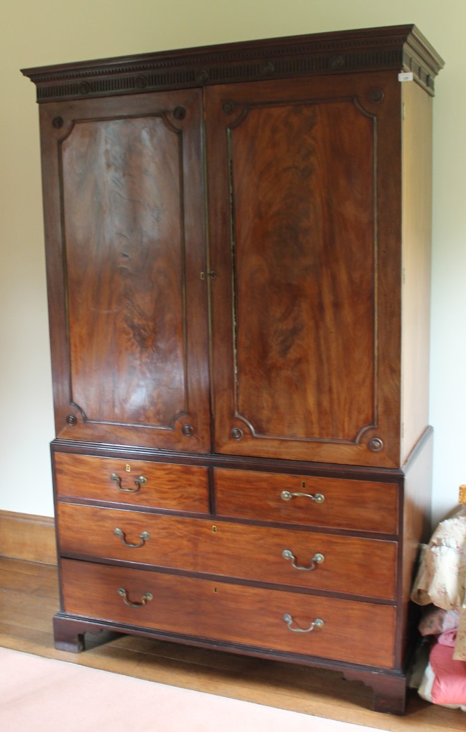 Appraisal: An early thC flamed mahogany linen press with dentil and