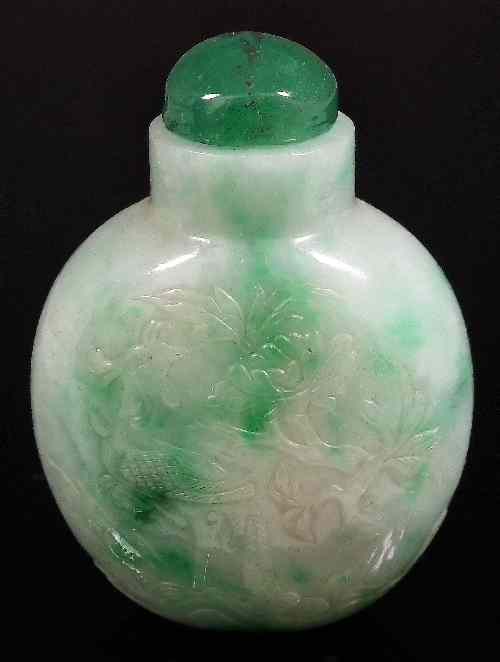 Appraisal: A Chinese green and white jadeite snuff bottle and stopper