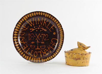 Appraisal: A Devon slipware moneybox the knop formed as a bird