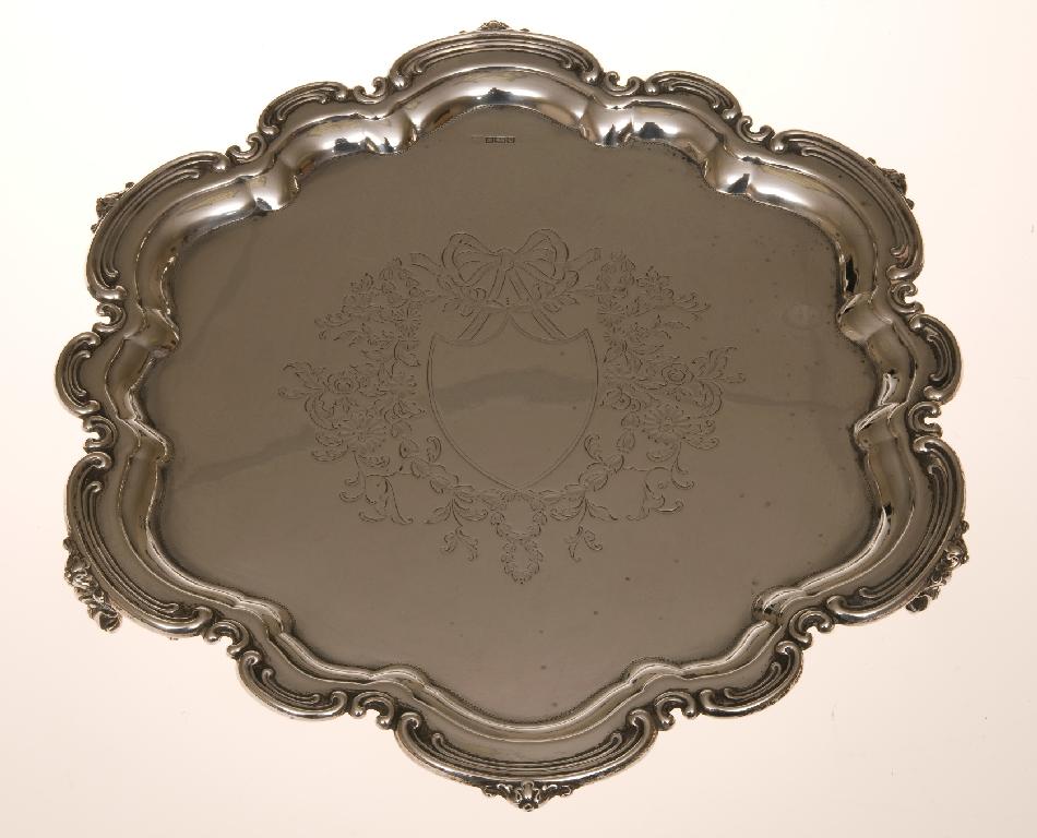 Appraisal: EDWARDIAN SILVER SALVER SHEFFIELD with scalloped c-scroll rim engraved with