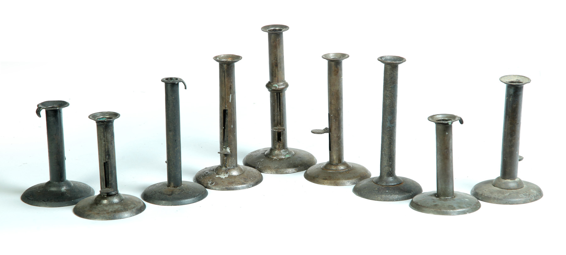 Appraisal: NINE HOG SCRAPPER CANDLESTICKS American mid th century Various heights