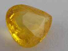 Appraisal: A loose polished yellow sapphire approx carats x mm