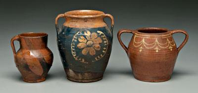 Appraisal: Three earthenware vessels urn with floral slip decoration on blue