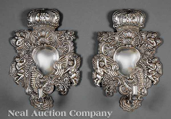 Appraisal: A Pair of Spanish Colonial Silverplate Repouss Wall Sconces late