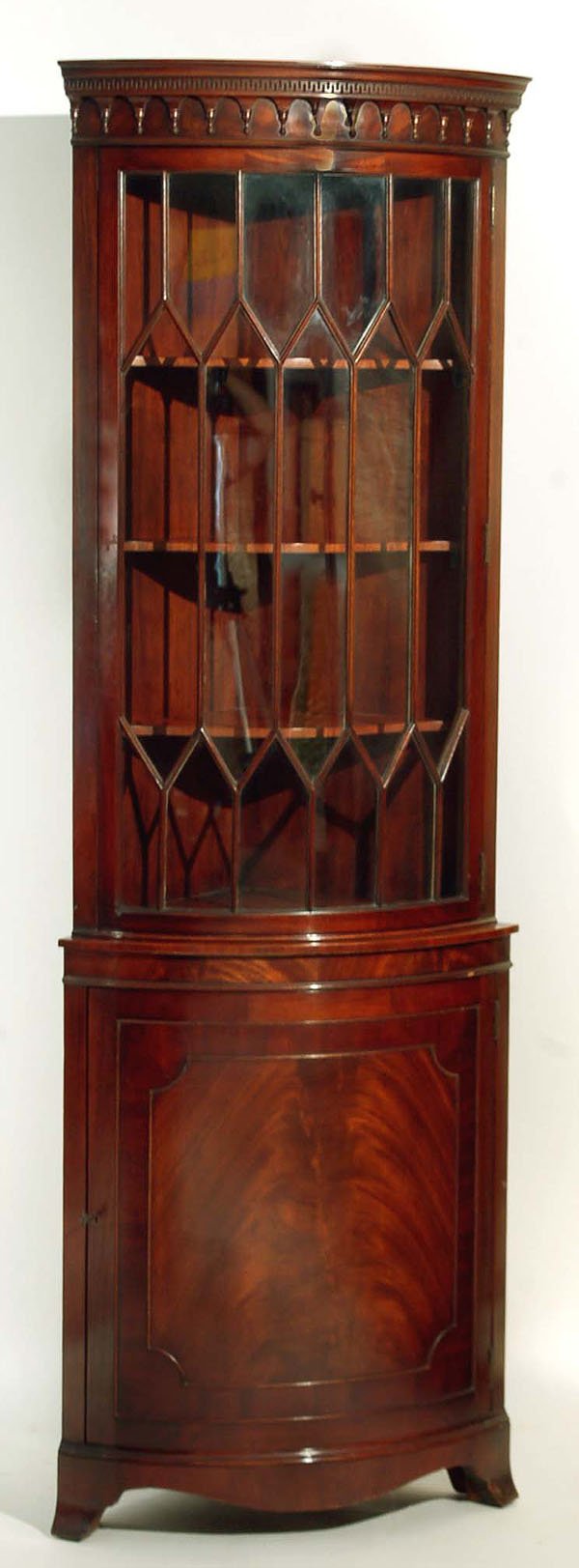 Appraisal: A mixed woods and mahogany barrel form corner cupboard marked