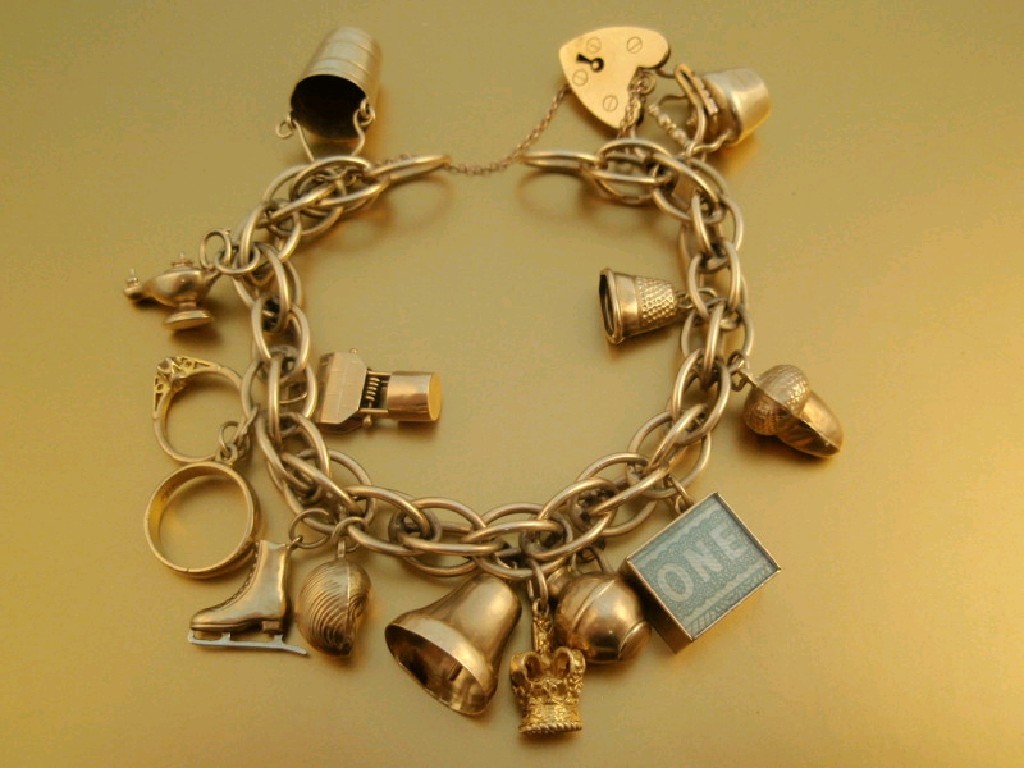 Appraisal: A ct gold charm bracelet thirteen charms attached g all