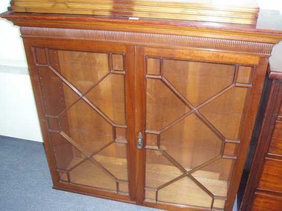 Appraisal: A mahogany display cabinet the glazed doors enclosing shelves