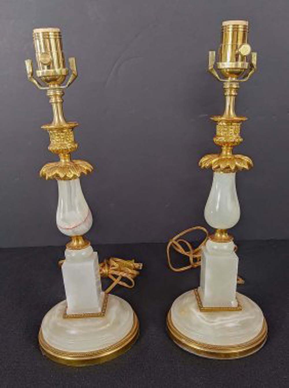 Appraisal: PAIR OF GILT BRONZE MOUNTED ONYX TABLE LAMPSThe segmented standards