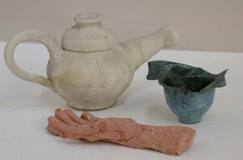 Appraisal: Teacup and Unglazed Teapot with Hand Ceramic on Ceramic Caplan