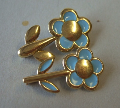 Appraisal: Two gold and pale blue enameled brooches designed as single