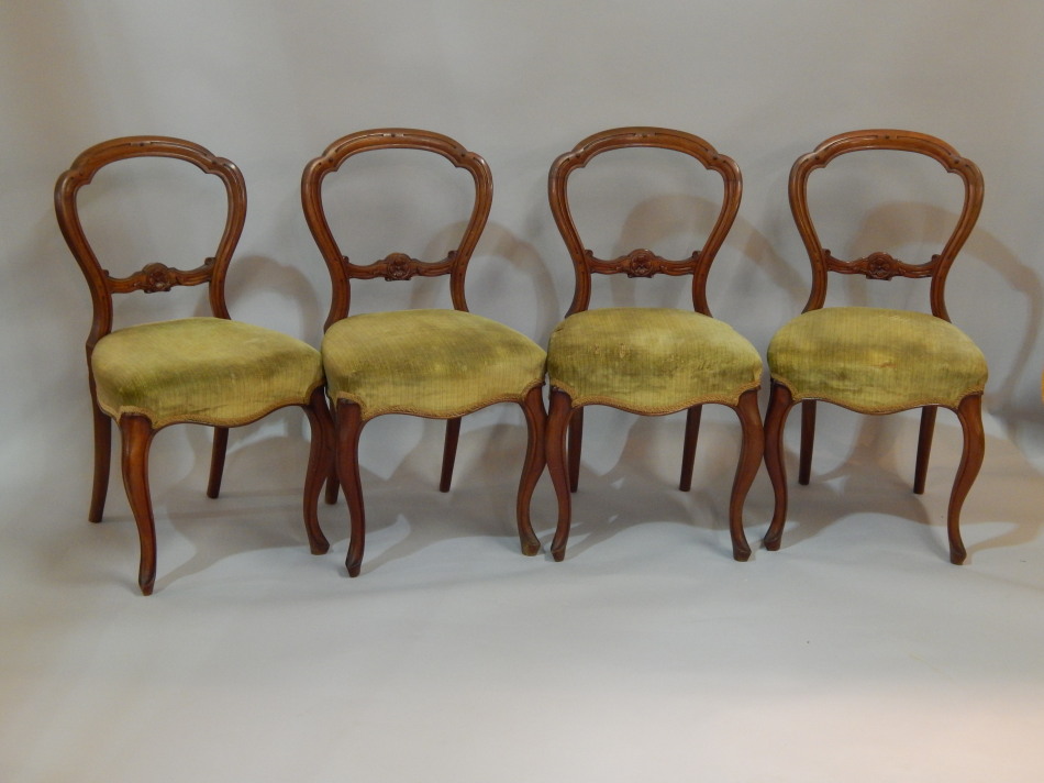 Appraisal: A set of four mahogany balloon back dining chairs with