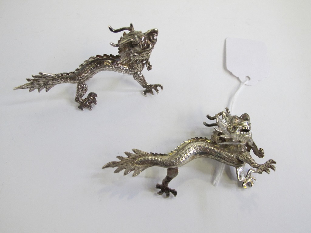 Appraisal: Pair of white metal dragon figures