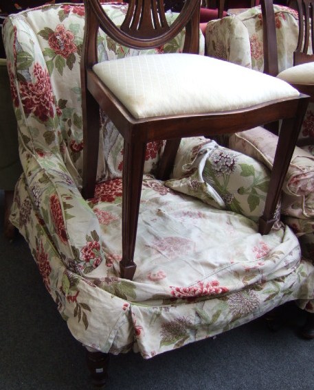 Appraisal: A th century mahogany framed low wing armchair raised on