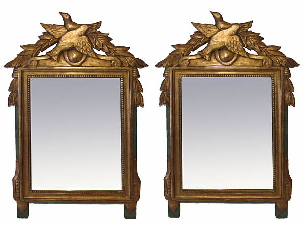 Appraisal: A pair of carved giltwood mirrors with bird cresting height