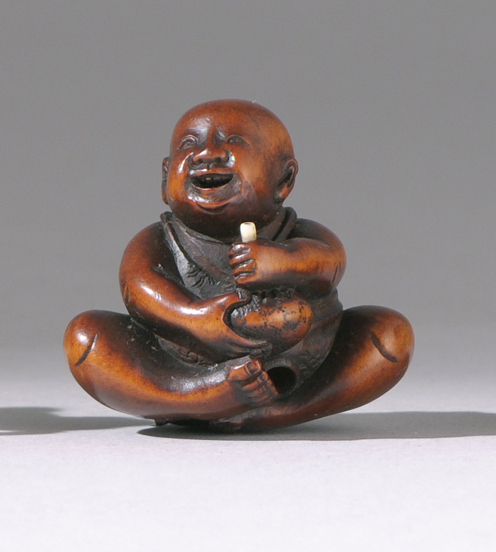 Appraisal: WOOD NETSUKE Mid- th CenturyDepicting a karako holding a candle