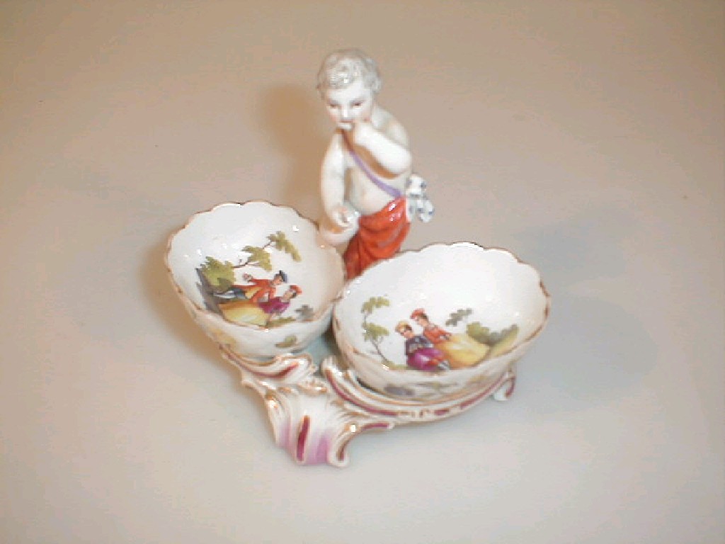 Appraisal: A Berlin porcelain ornament as a cherub between two oval