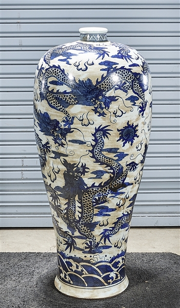 Appraisal: Tall Chinese blue and white porcelain vase depicting dragons chasing