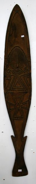 Appraisal: A carved wooden shield decorated with burnt detail Papua New