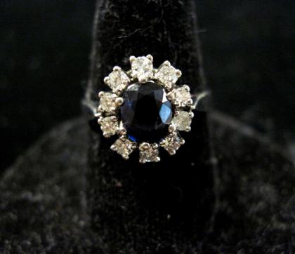 Appraisal: karat white gold sapphire ringOval shaped sapphire within a nine