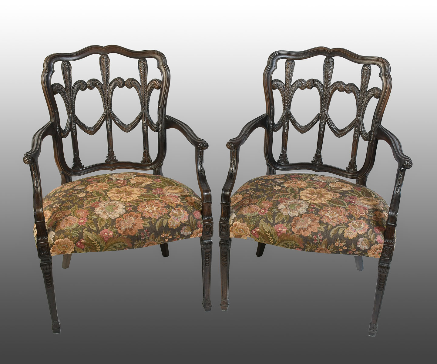 Appraisal: PAIR OF CARVED HEPPLEWHITE STYLE ARMCHAIRS Ebonized frame with scrolling