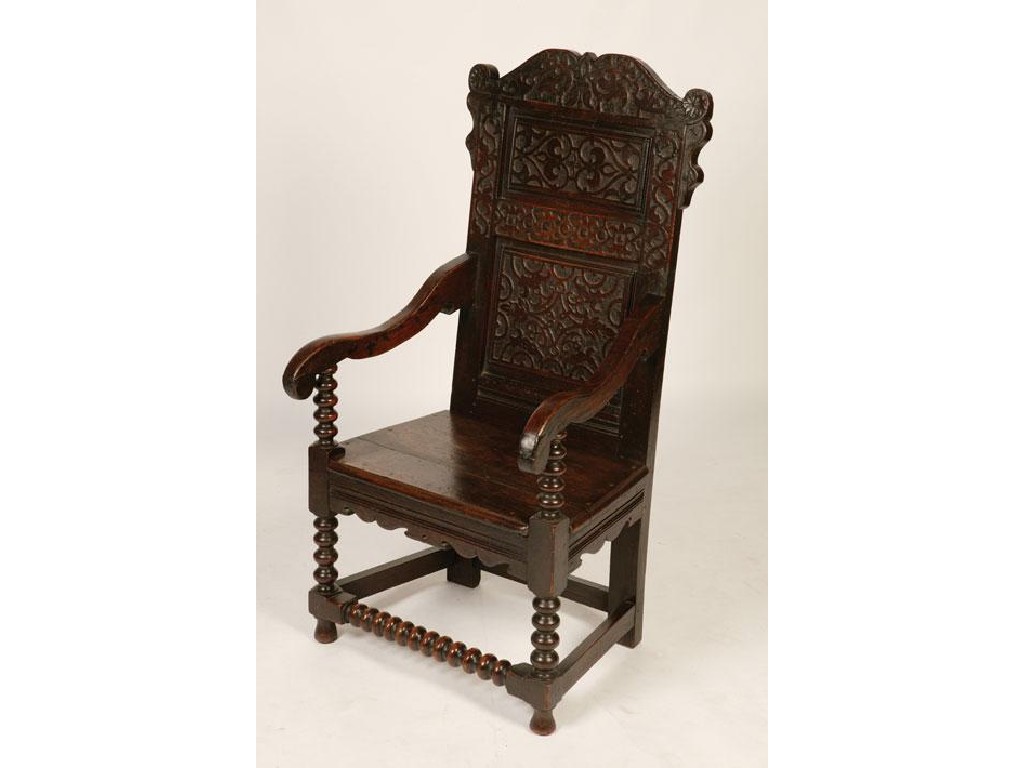 Appraisal: A CHARLES II OAK WAINSCOT CHAIR with a scrolling top