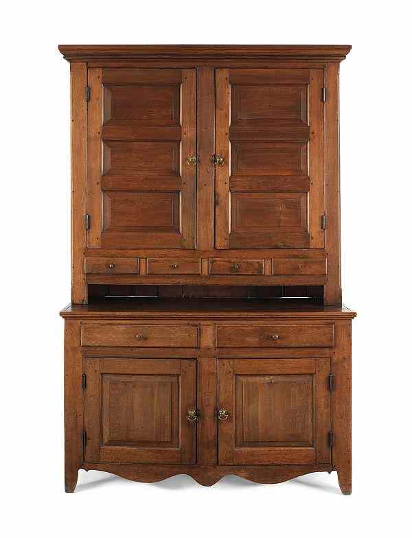 Appraisal: Pennsylvania walnut two-part Dutch cupboard early th c with raised