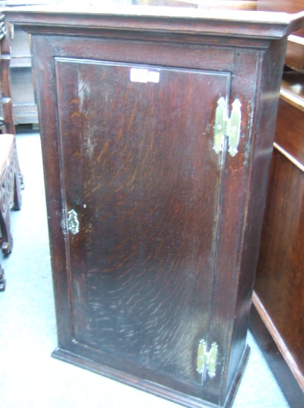 Appraisal: A th century oak cupboard with single door and brass