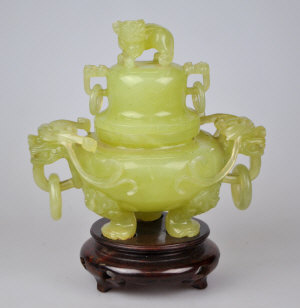 Appraisal: A Chinese green hardstone Koro cover carved with loose ring