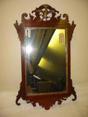 Appraisal: A MAHOGANY FRET FRAMED WALL MIRROR of oblong form with