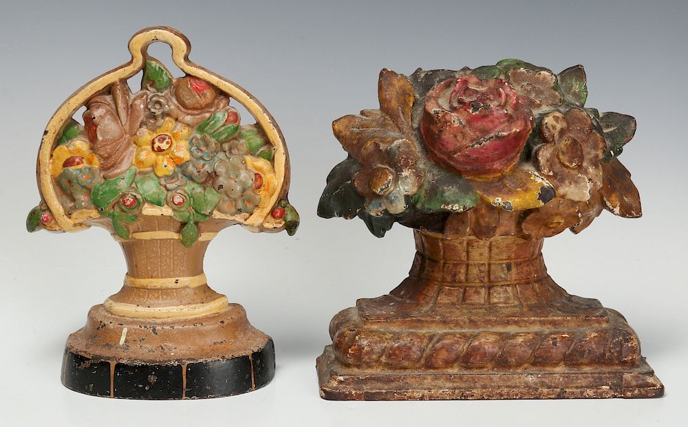 Appraisal: TWO CAST IRON FLOWER BASKET FIGURAL DOOR STOPS Two nice