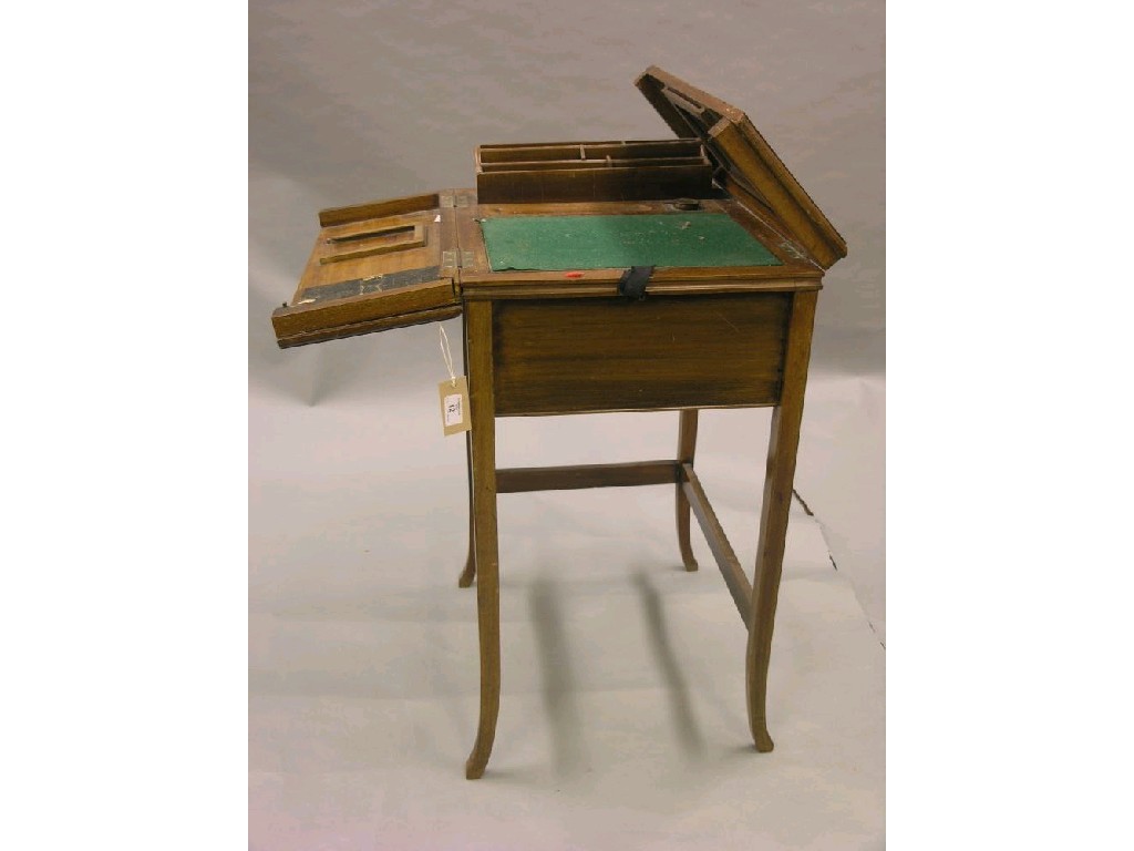 Appraisal: An Edwardian portable walnut writing table the top opening in