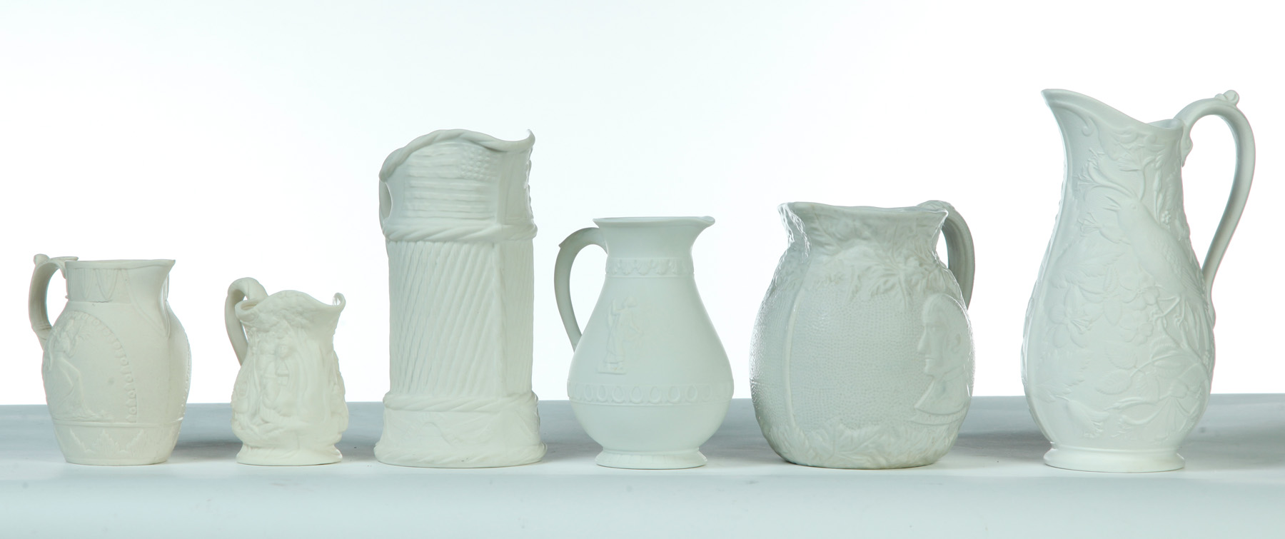 Appraisal: SIX RELIEF MOLDED PITCHERS England mid th century Various makers