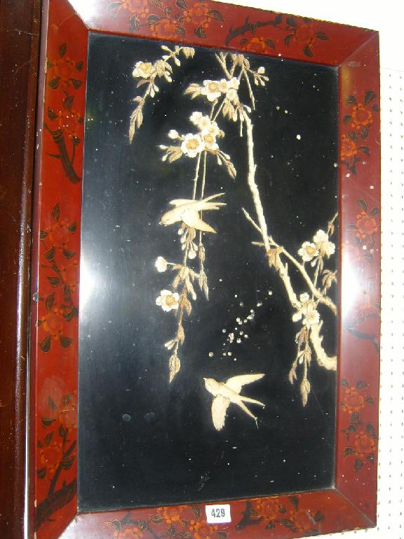 Appraisal: An oriental lacquered panel with carved ivory relief decoration of