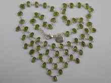 Appraisal: A white metal tests silver and peridot fringe necklace approx