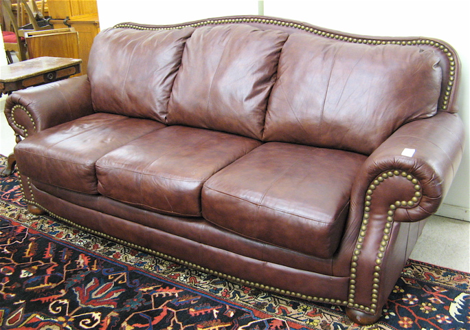 Appraisal: TRADITIONAL STYLE BROWN LEATHER SOFA recent manufacture overall medium brown