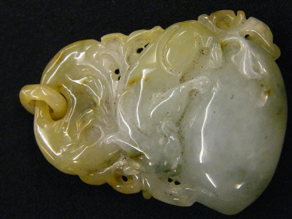 Appraisal: Interesting pierced pale green and light brown jade pendant carved