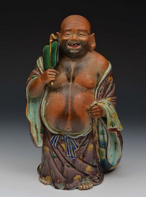 Appraisal: A JAPANESE GLAZED KUTANI PORCELAIN MODEL OF HOTEI holding a