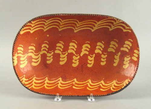 Appraisal: Redware loaf dish th c with a vibrant yellow slip