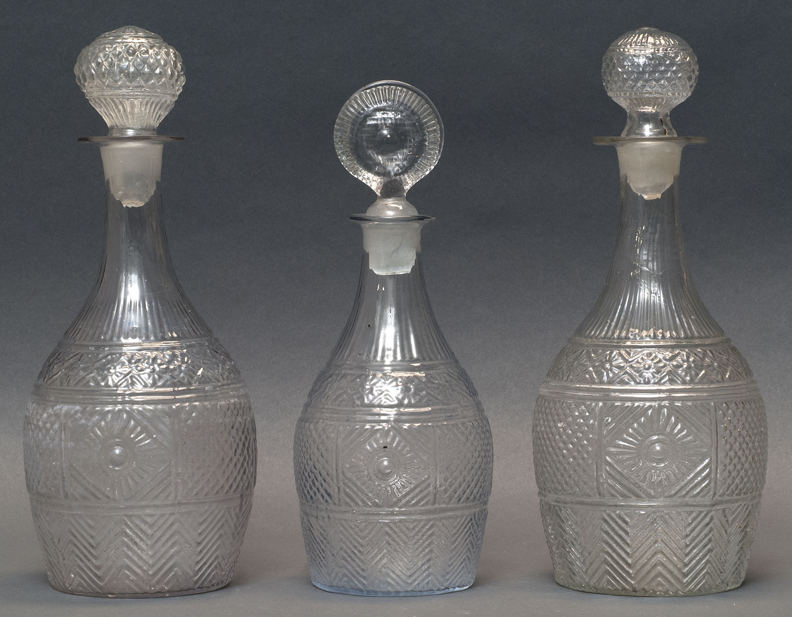 Appraisal: THREE CLEAR GLASS BLOWN -MOLD DECANTERS Second Quarter of the