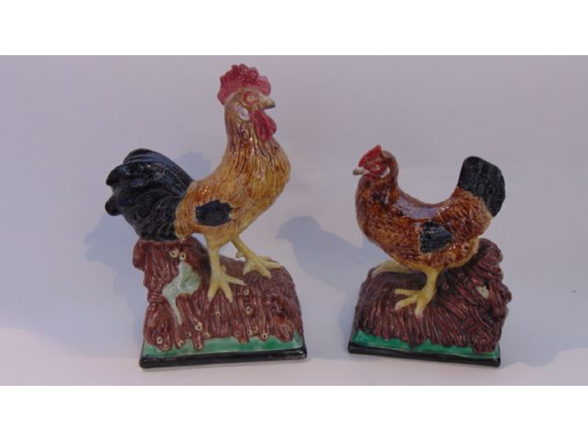 Appraisal: A pair of Portuguese models of a cockerel and a