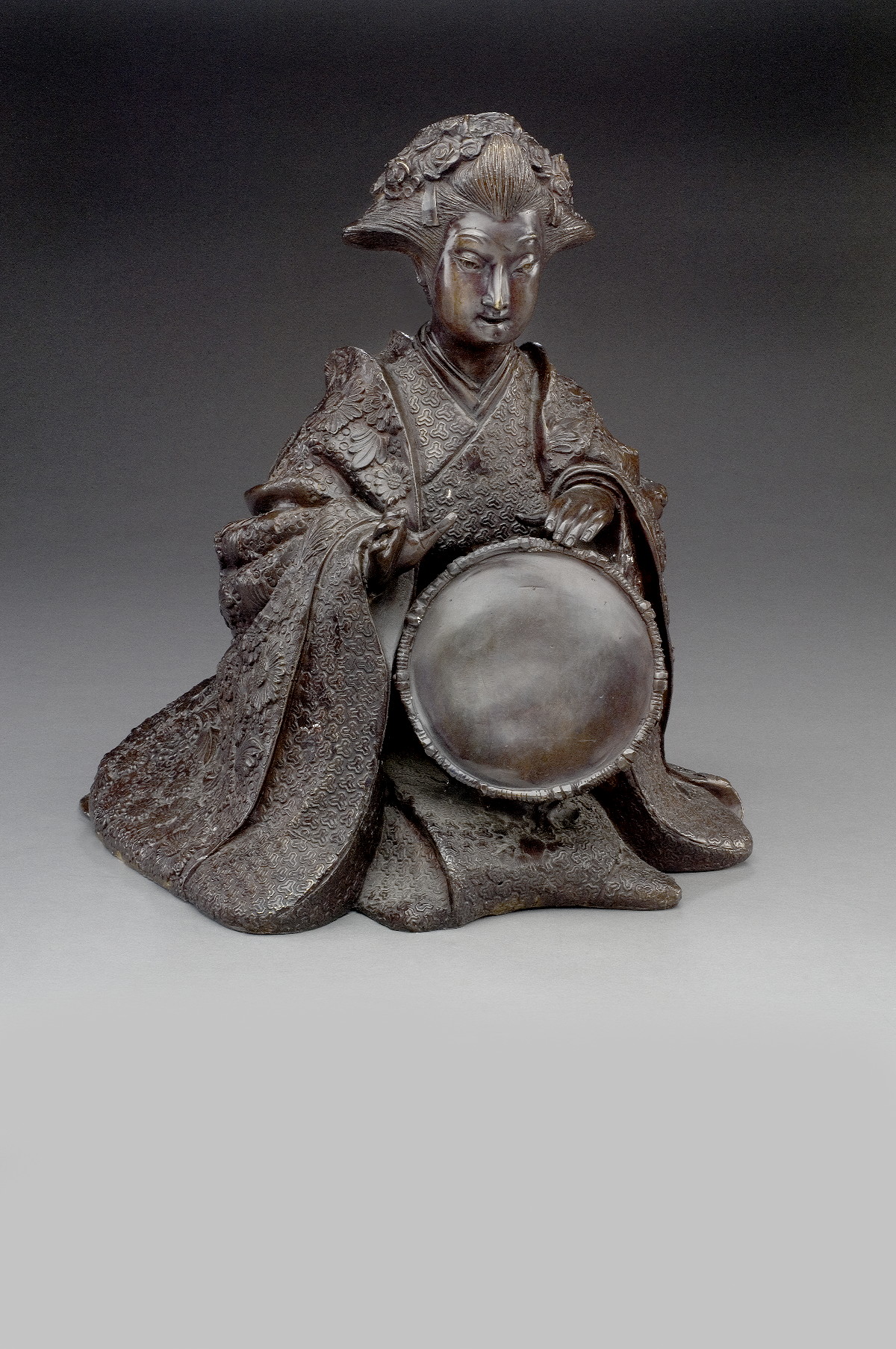 Appraisal: JAPANESE BRONZE FIGURE OF A GEISHA Cast kneeling and playing