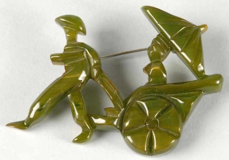 Appraisal: Bakelite Green Rickshaw Pin Description s Highly carved Condition Excellent