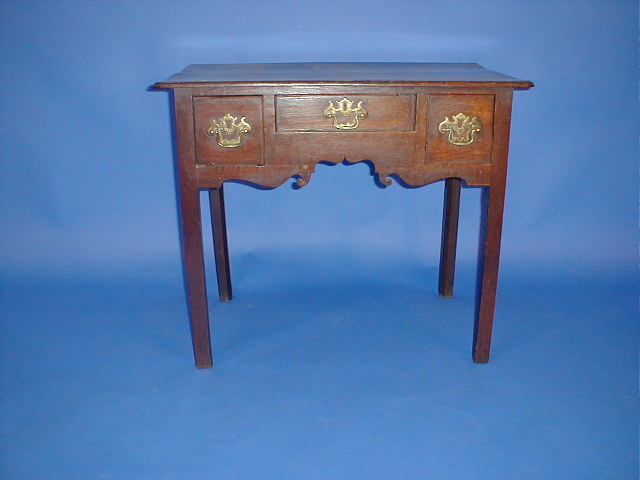 Appraisal: A George II oak low boy with three drawers and