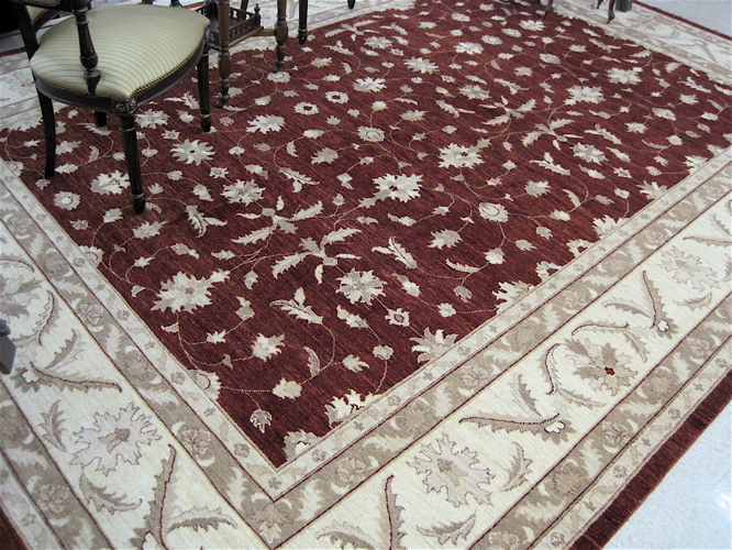 Appraisal: HAND KNOTTED ORIENTAL CARPET Pakistani-Persian overall floral tracery on maroon