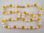 Appraisal: A cultured pearl and yellow bead necklace with a yellow