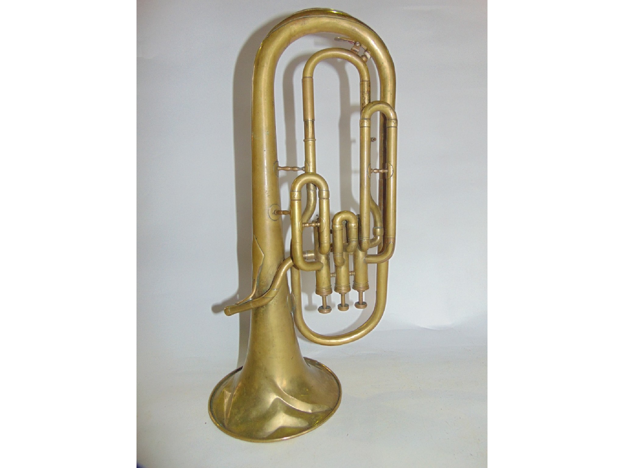 Appraisal: An antique brass French sax horn by Adolphase Cie stamped